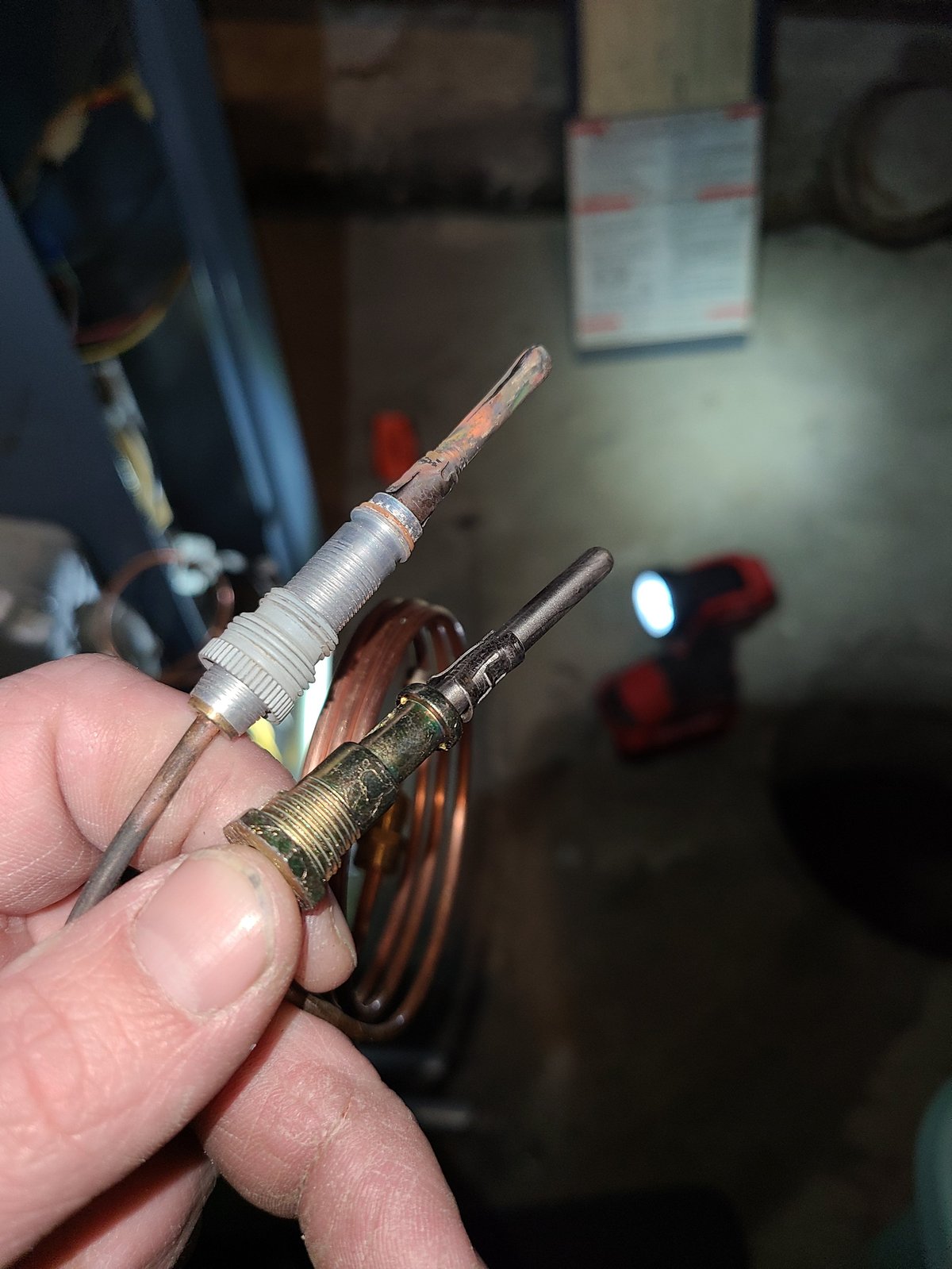 Clark's technician holding soldering iron tips used for boiler and oil burner repair