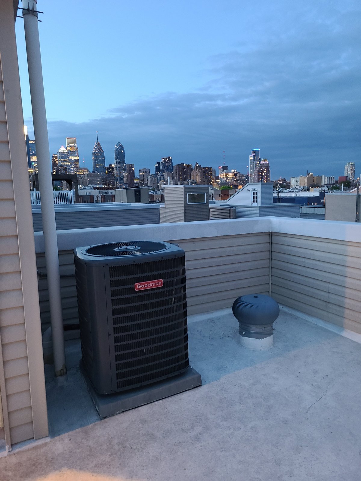 Goodman air conditioning unit installed by Clark's Heating and Cooling on a rooftop overlooking the city