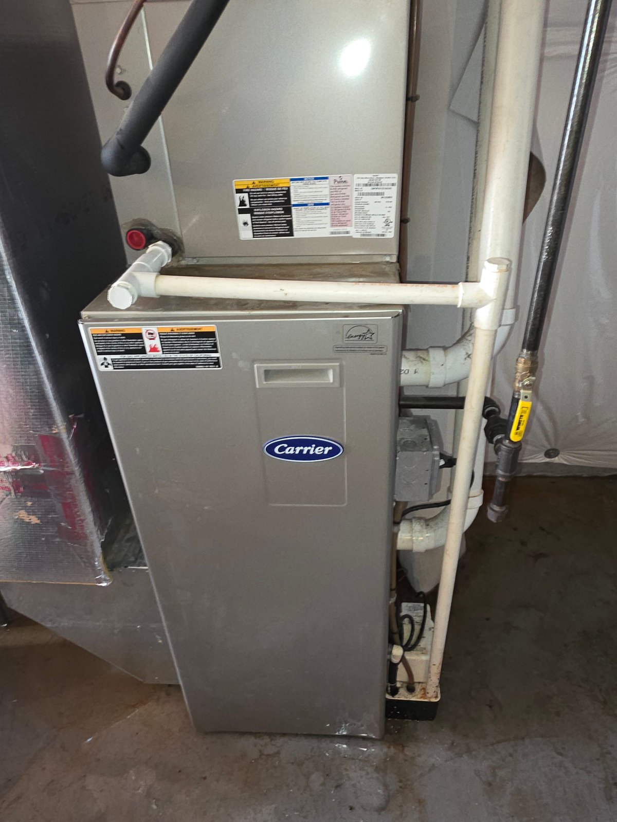 Carrier furnace unit serviced by Clark's Heating and Cooling, showing the front control panel and labels